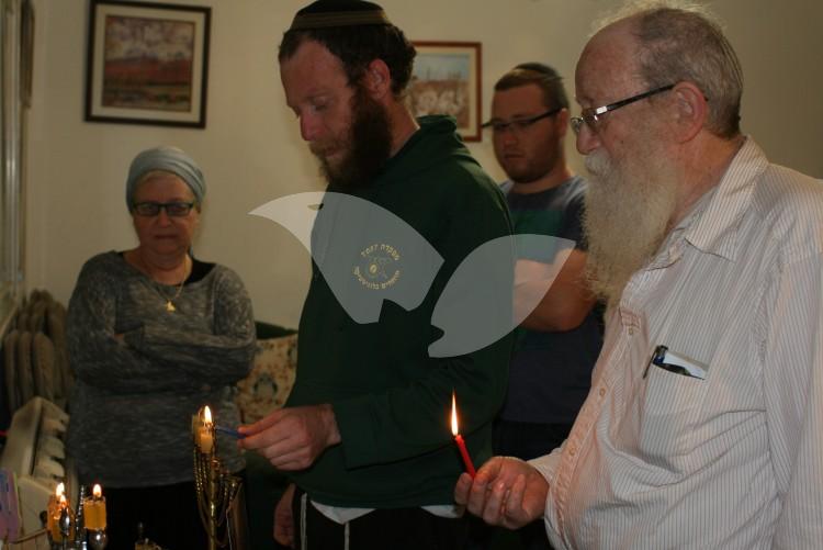 Mansbach familiy lighting historic menorah