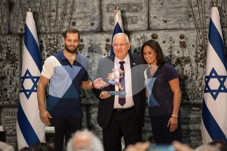 Alex Shatilov (L) and Yarden Gerbi (R) Give Gift to President Rivlin (Center)