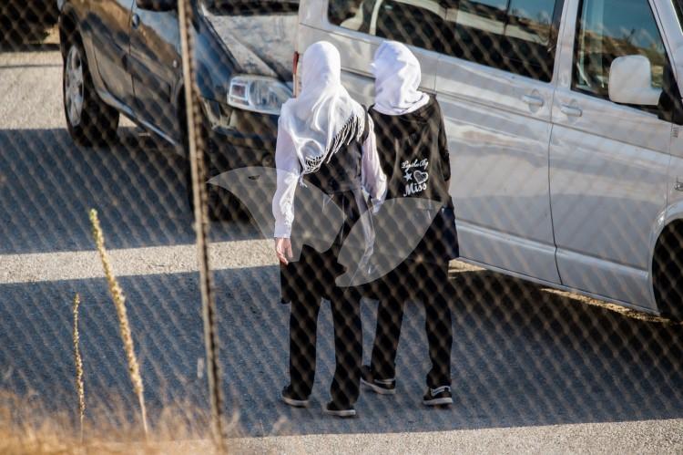 Palestinian girls walk outside