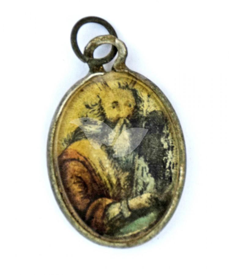 A metal locket covered with glass with the image of Moses holding the Ten Commandments