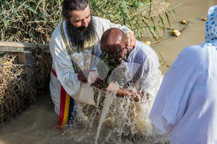 Christian Orthodox pilgrims participate in the baptism of Jesus, during the traditional Epiphany baptism ceremony at the Qasr-el Yahud baptism site in the Jordan river near the West Bank town of Jericho.
