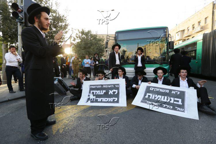 Jerusalem faction holding signs and blocking the road in Jerusal
