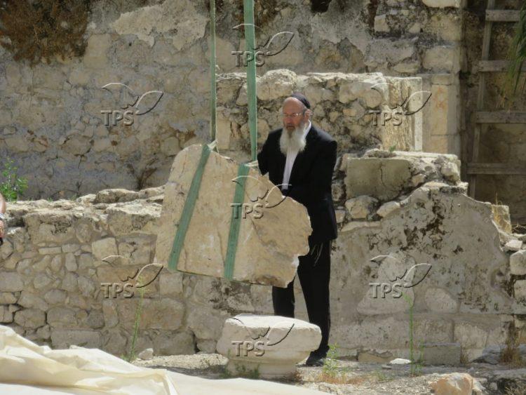 Detached Western Wall stone being removed from compound
