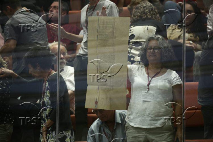 A protestor holding up a copy of Israel’s Declaration of Independence