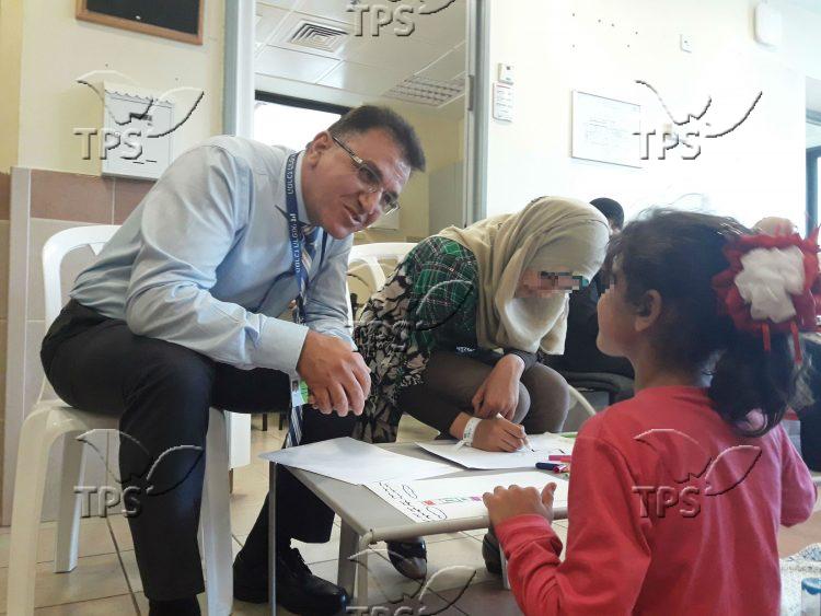 Dr. Salman Zarka – Director of Ziv Medical center with a Syrian girl and her mom (1)