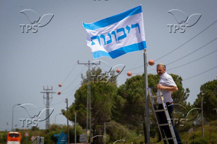 Shai Alon, the Head of  Beit El Council hangs sovereignty flag