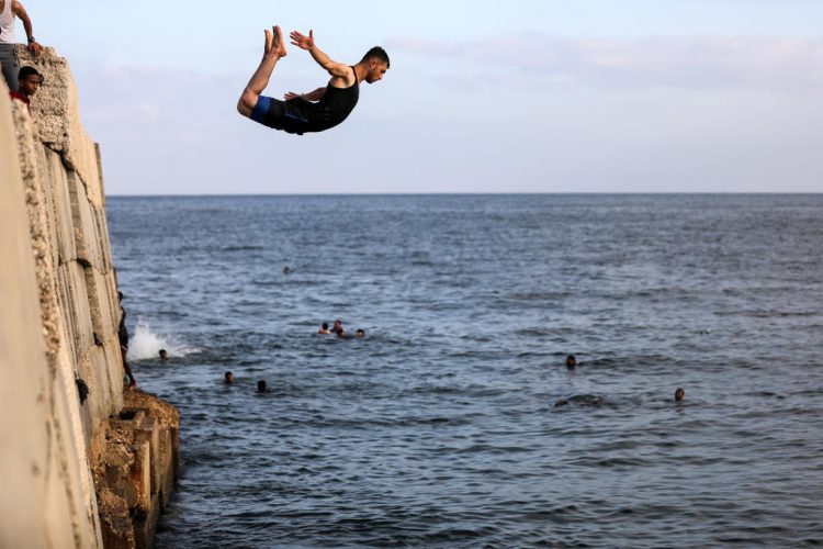 Youths enjoy the summertime by the sea in the Gaza Strip