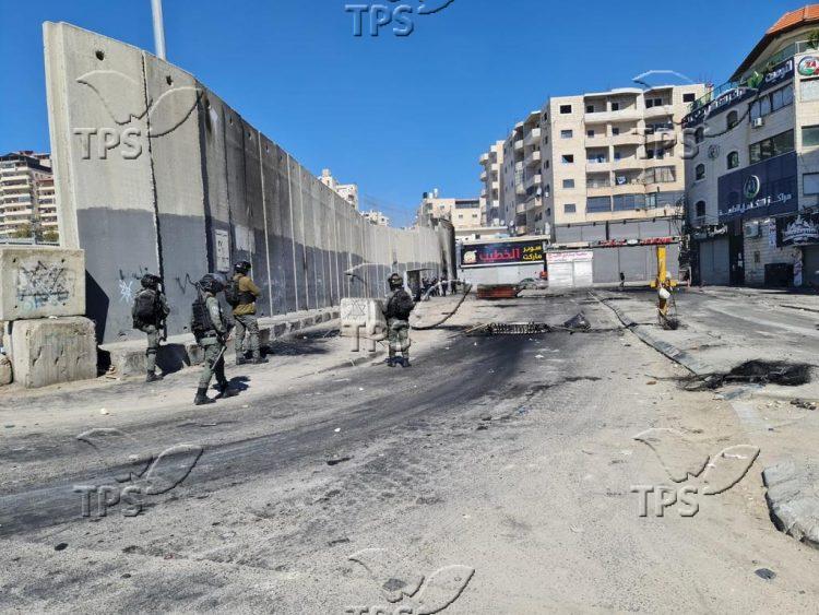 Israel Border Police block the entrance to Shuafat