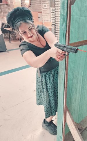 A woman shooting on a range