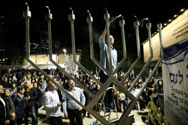 Family of Israeli Hostage Omar Shem Tov Lights Public Menorah 7th Night of Chanukah