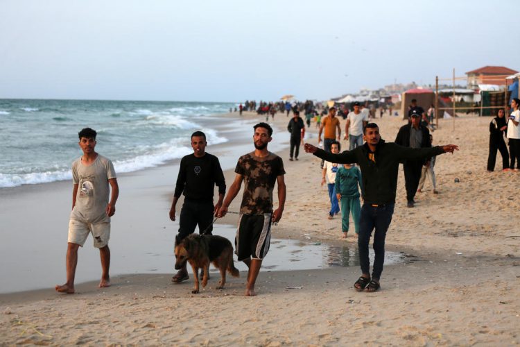 Palestinians enjoy the beach on the 7th month of the Iron Swords war